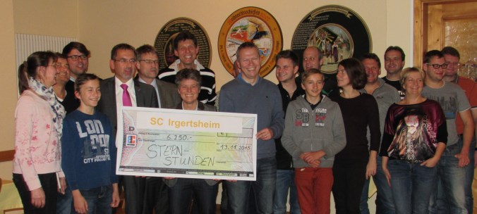 Wolfgang Haas (5. v. li.) nahm den symbolischen Scheck entgegen. Auf dem Bild sind u. a. auch zu sehen: Evi Bauer (7. v. li.; Hauptorganisatorin des Sternstundentages) und Peter Dollinger (6. v. li. Vorsitzender SC Irgertsheim)